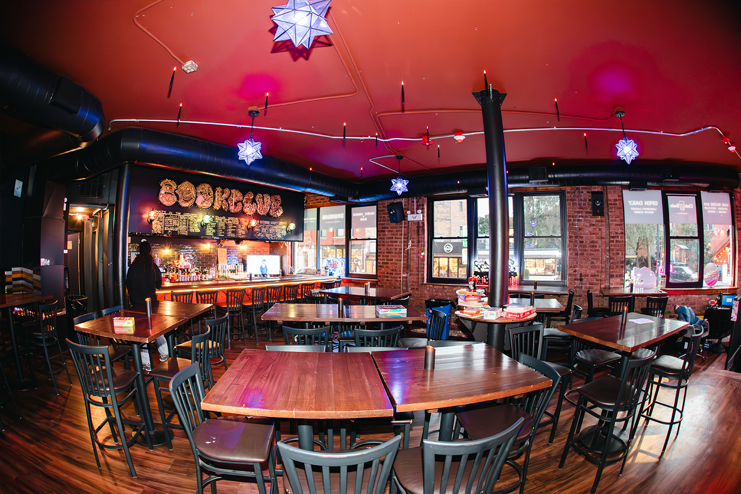 Bright, wide view of Club Soda seating and bar
