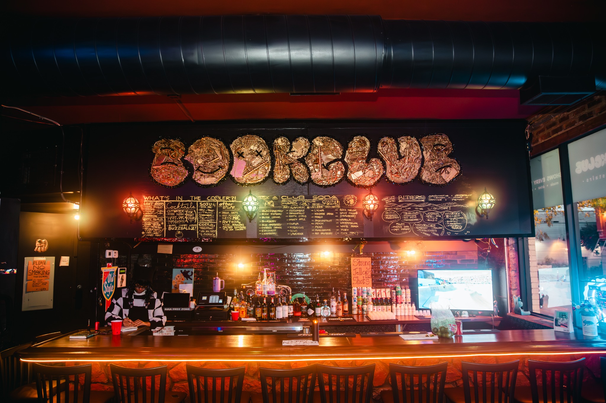 The illuminated BOOKCLUB bar and drinks counter in Lakeview, Chicago