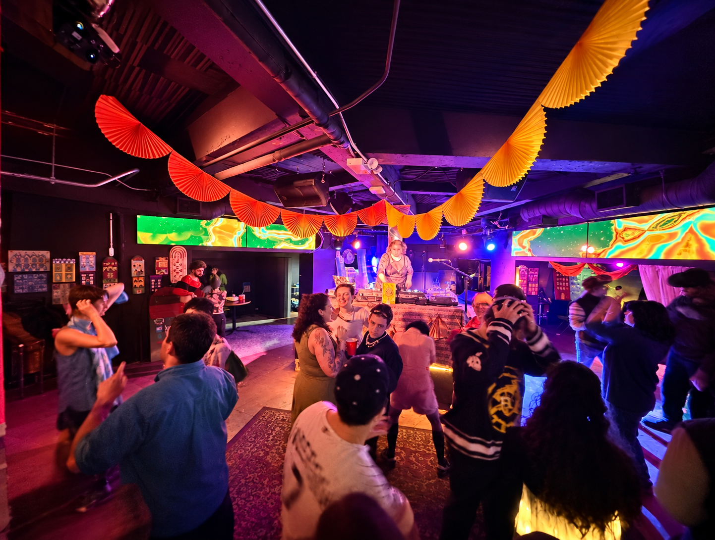 Guests enjoying colorful decorations and in-house production in Bookclub’s downstairs music venue